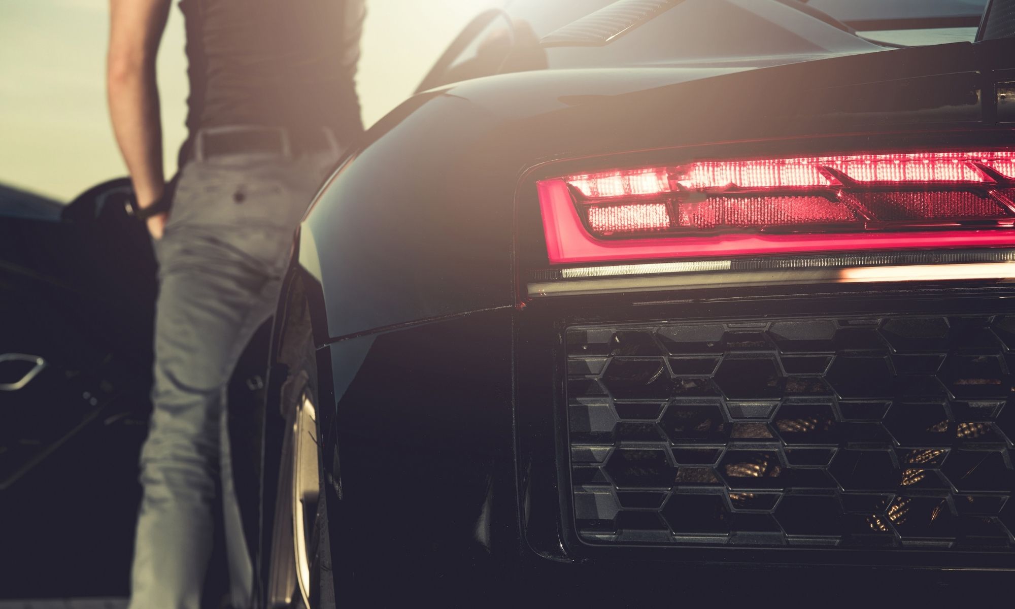 Modern dark sedan with illuminated taillight after Bravus detail